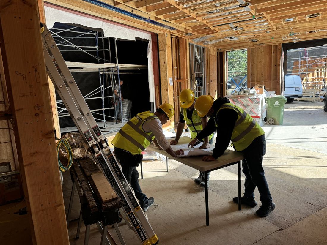 Rhino Air crew reviewing mechanical plans on a jobsite table