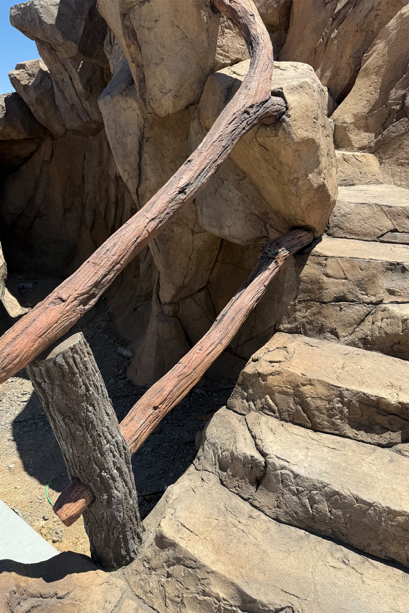 Stairs designed to look like a combination of natural stones and wooden logs or trunks.