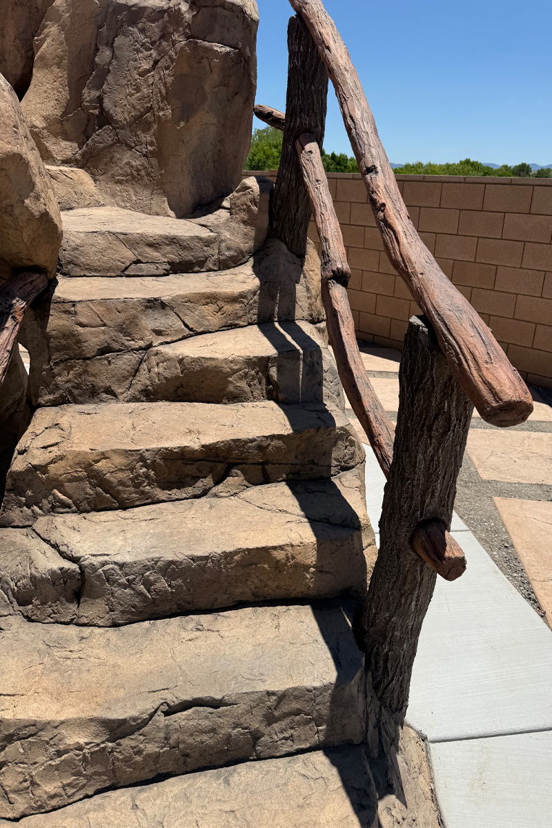 Stairs designed to look like a combination of natural stones and wooden logs or trunks.