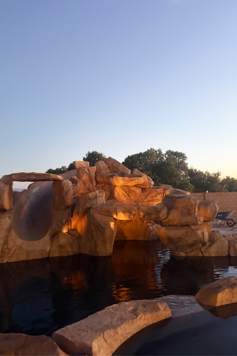 A swimming pool adjacent to or integrated with a stone structure.