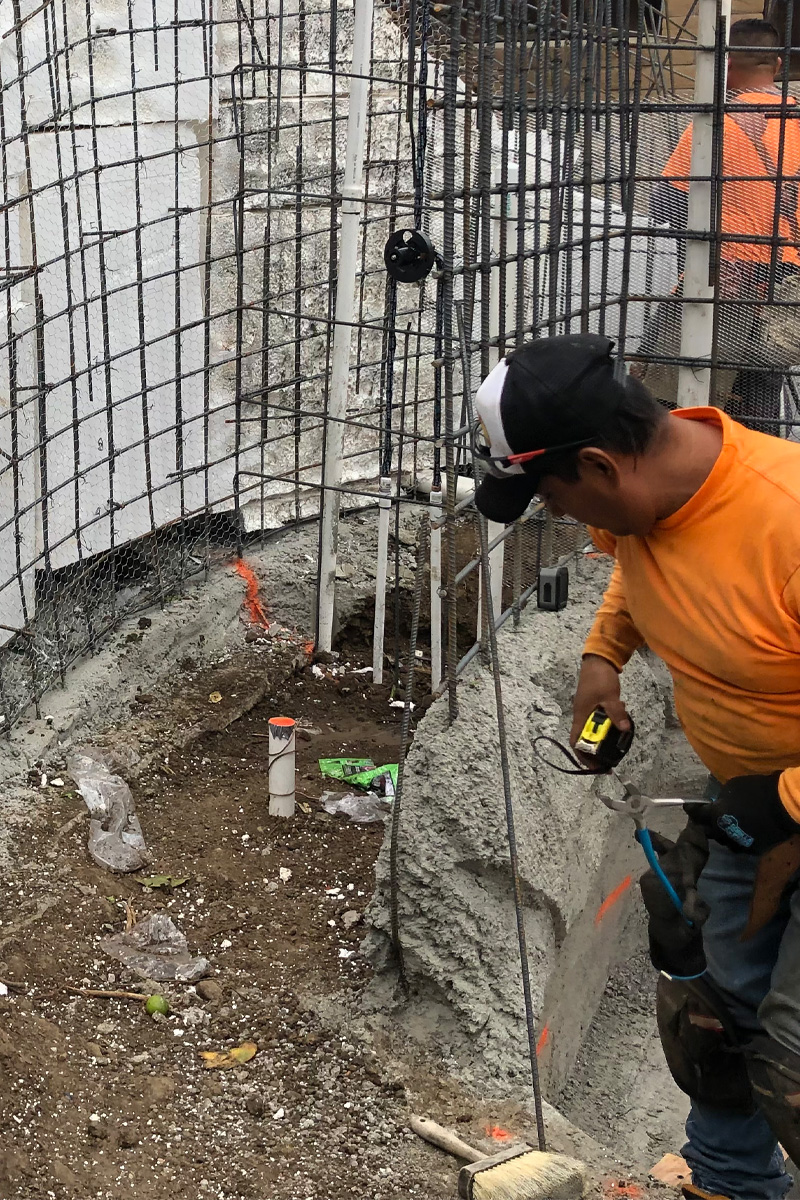  A worker is constructing an iron framework or structure.
