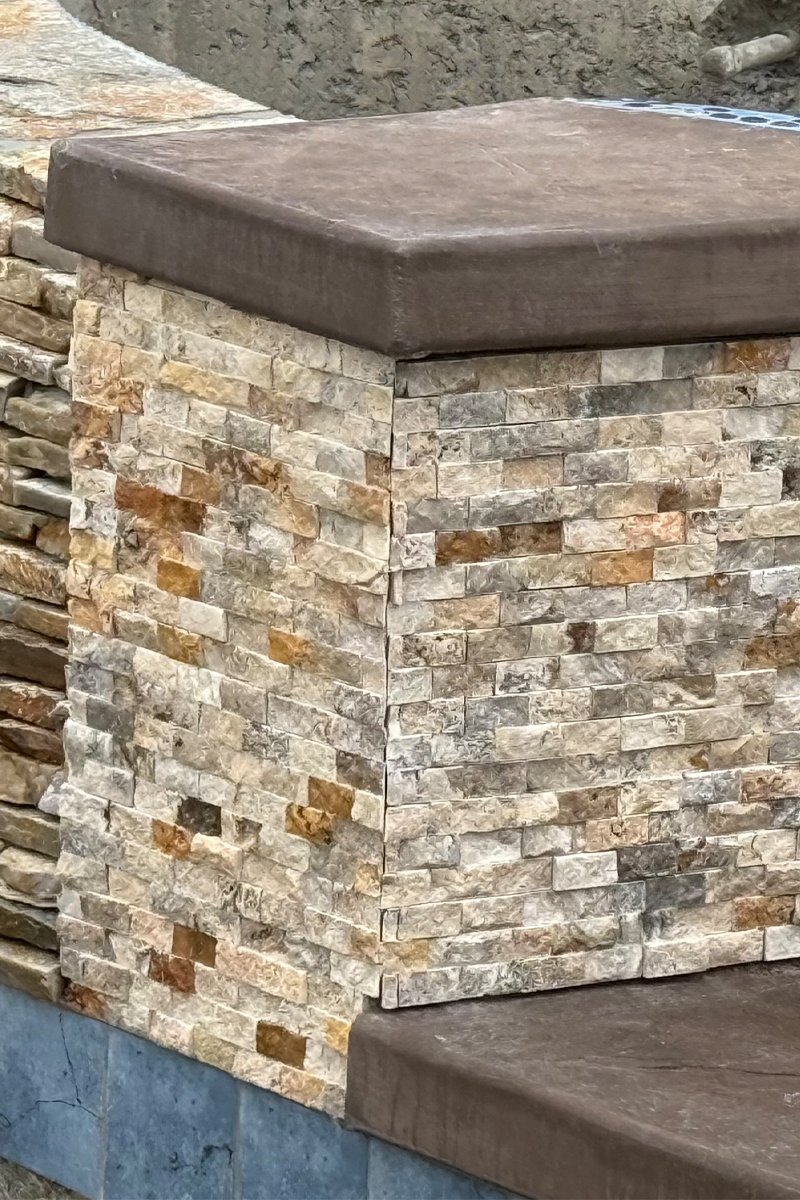 Details of tiles in various earth tones, such as browns, tans, and beiges.