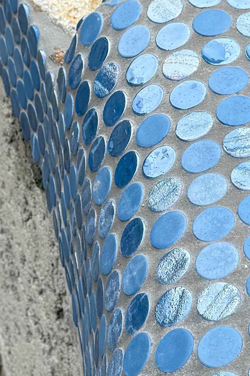 Blue tiles details on the edges of a swimming pool.
