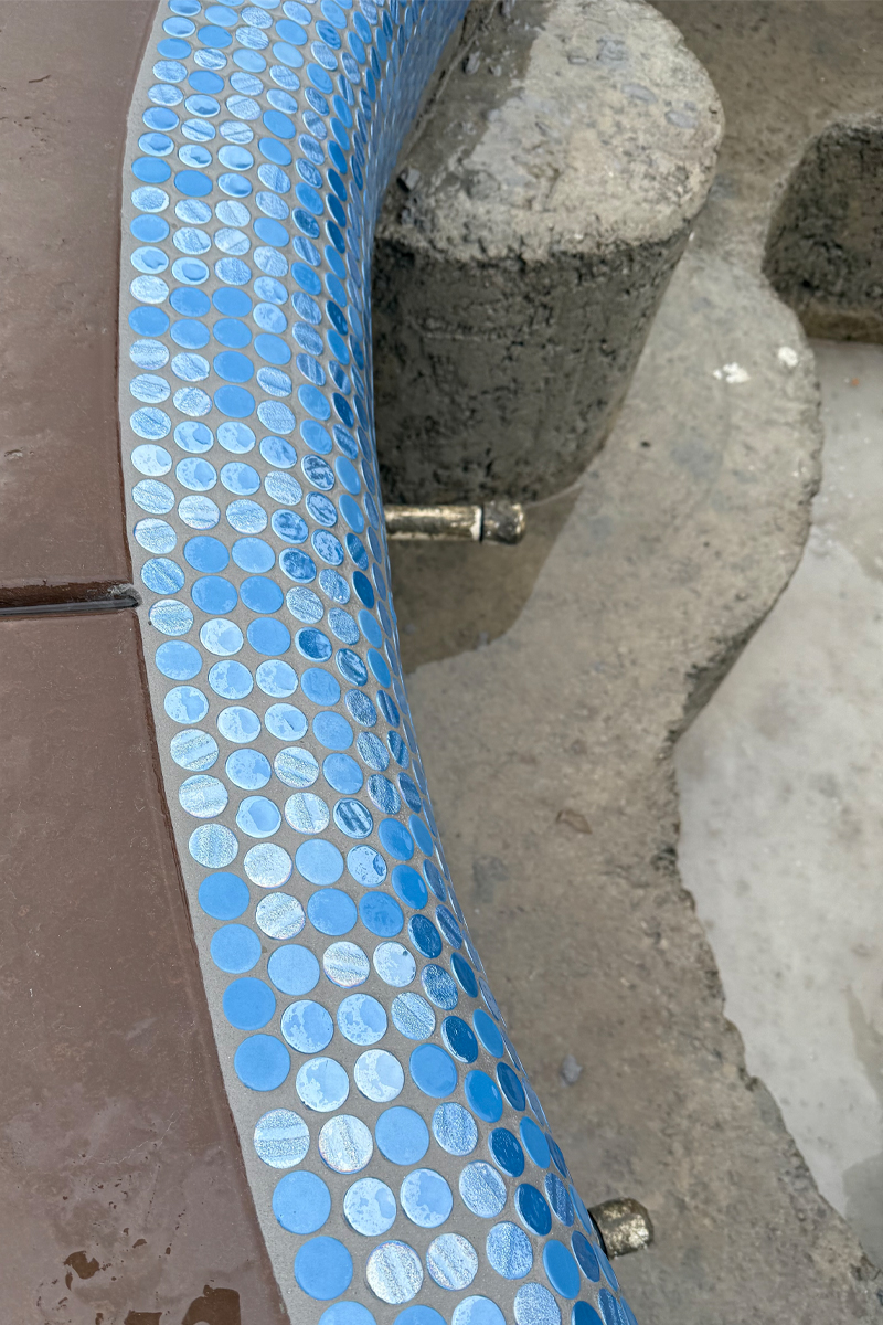 Blue tiles details on the edges of a swimming pool.