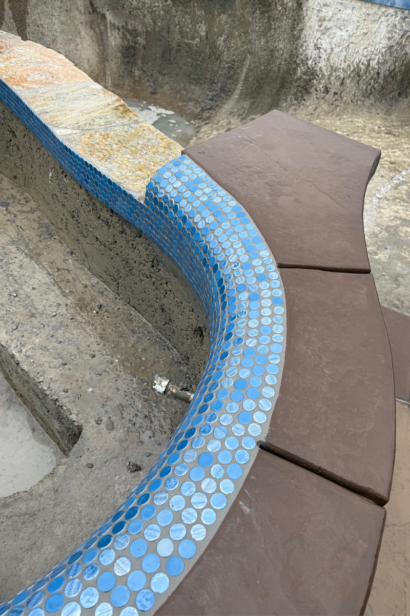 Blue tiles details on the edges of a swimming pool.