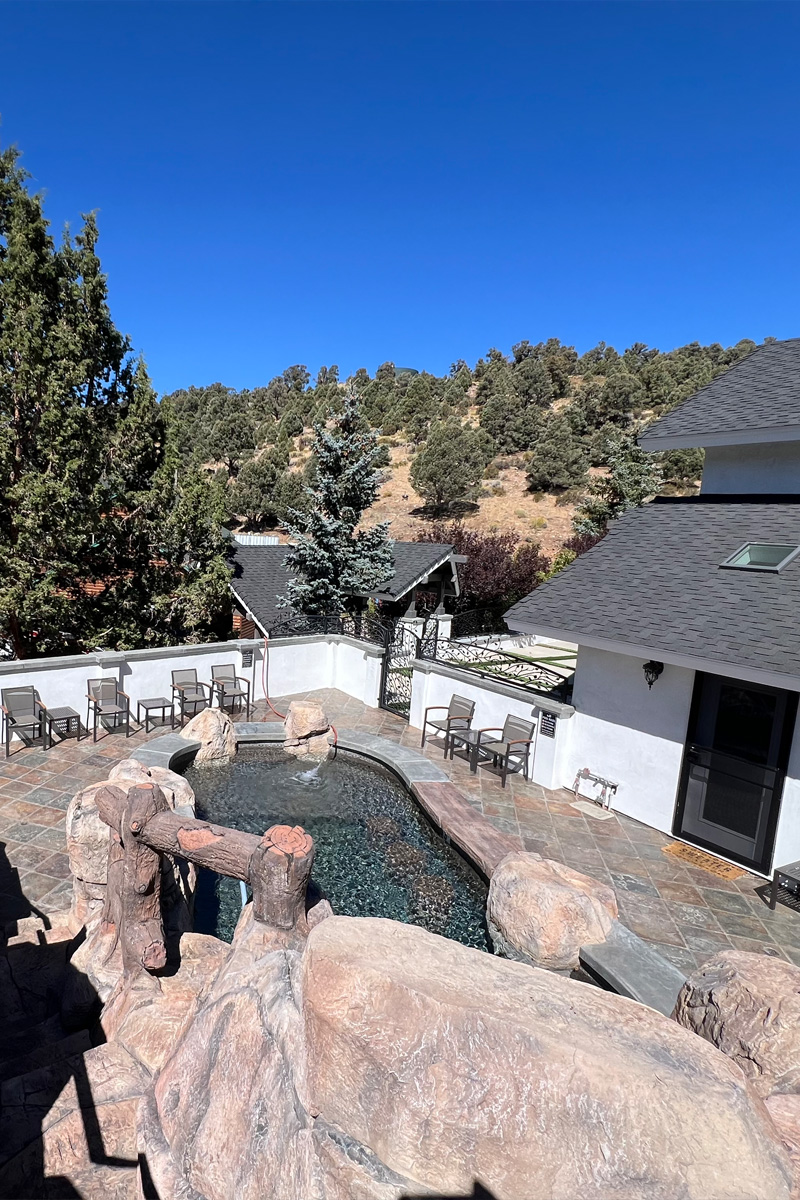 An overhead view of a beautiful swimming pool constructed with natural stones.