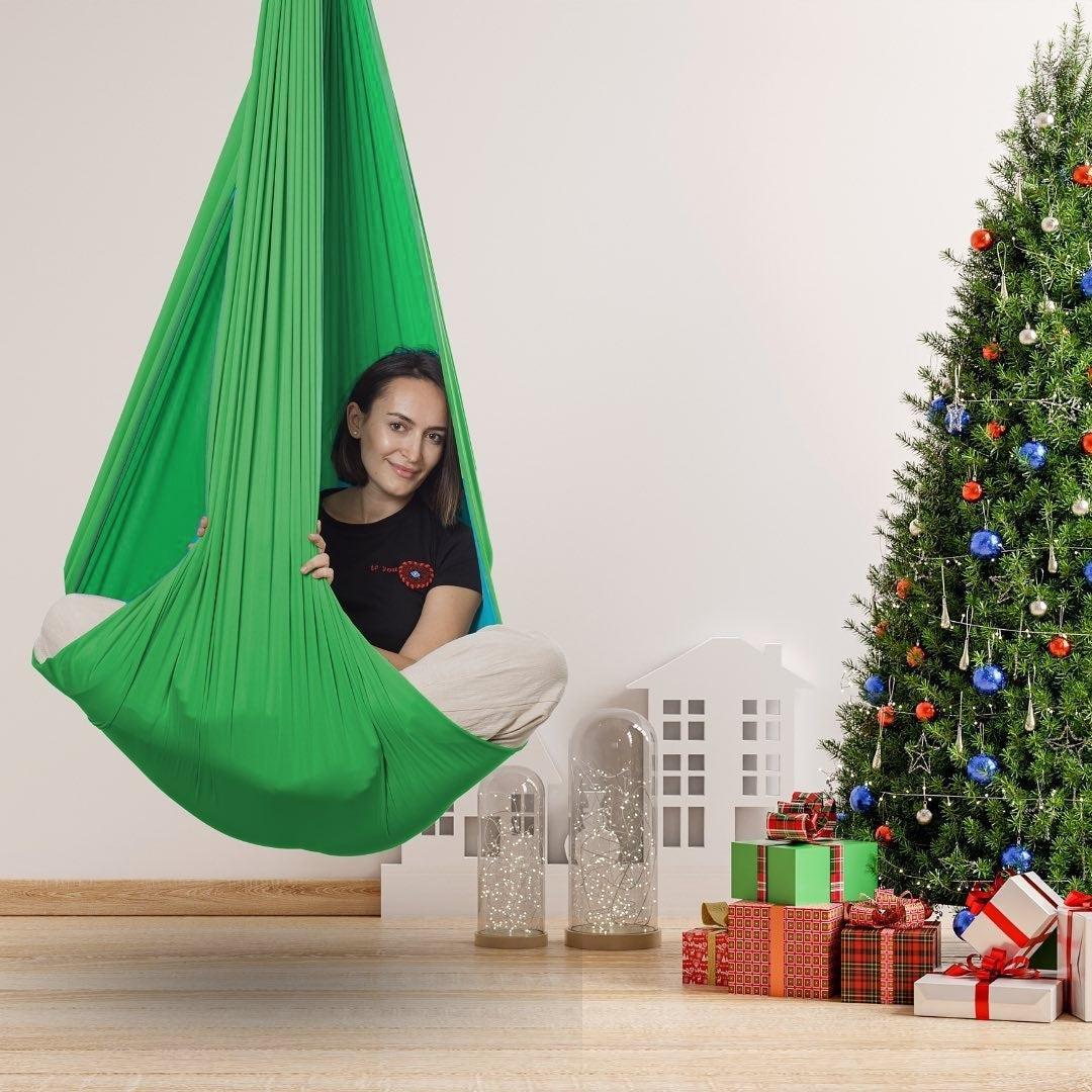 A cuddle swing providing deep pressure support in a home environment.