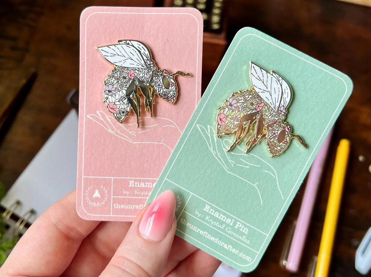 Enamel pins with flower or bee designs