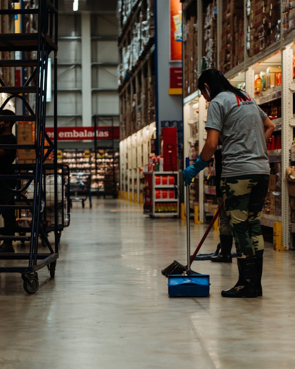 woman cleaning the floor supermarket