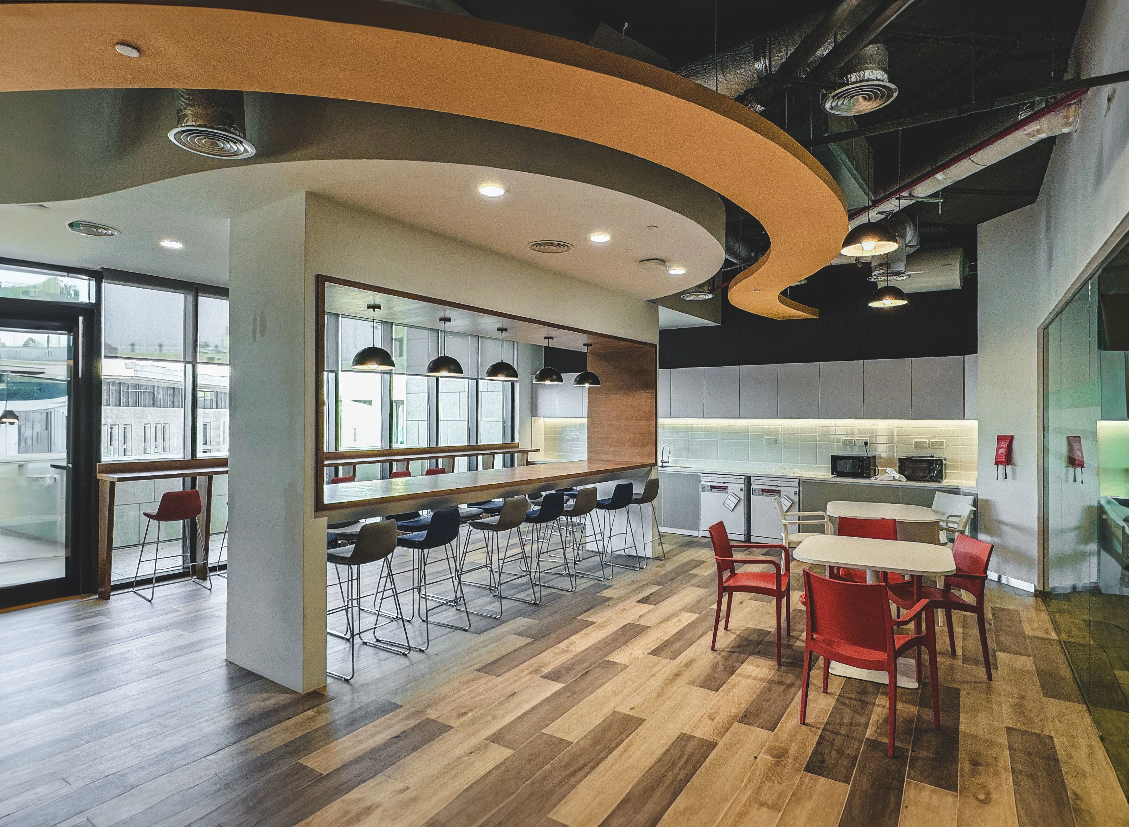 Schneider Electric breakout area with curved ceiling and bar-height seating, Msheireb, Doha, by Daya