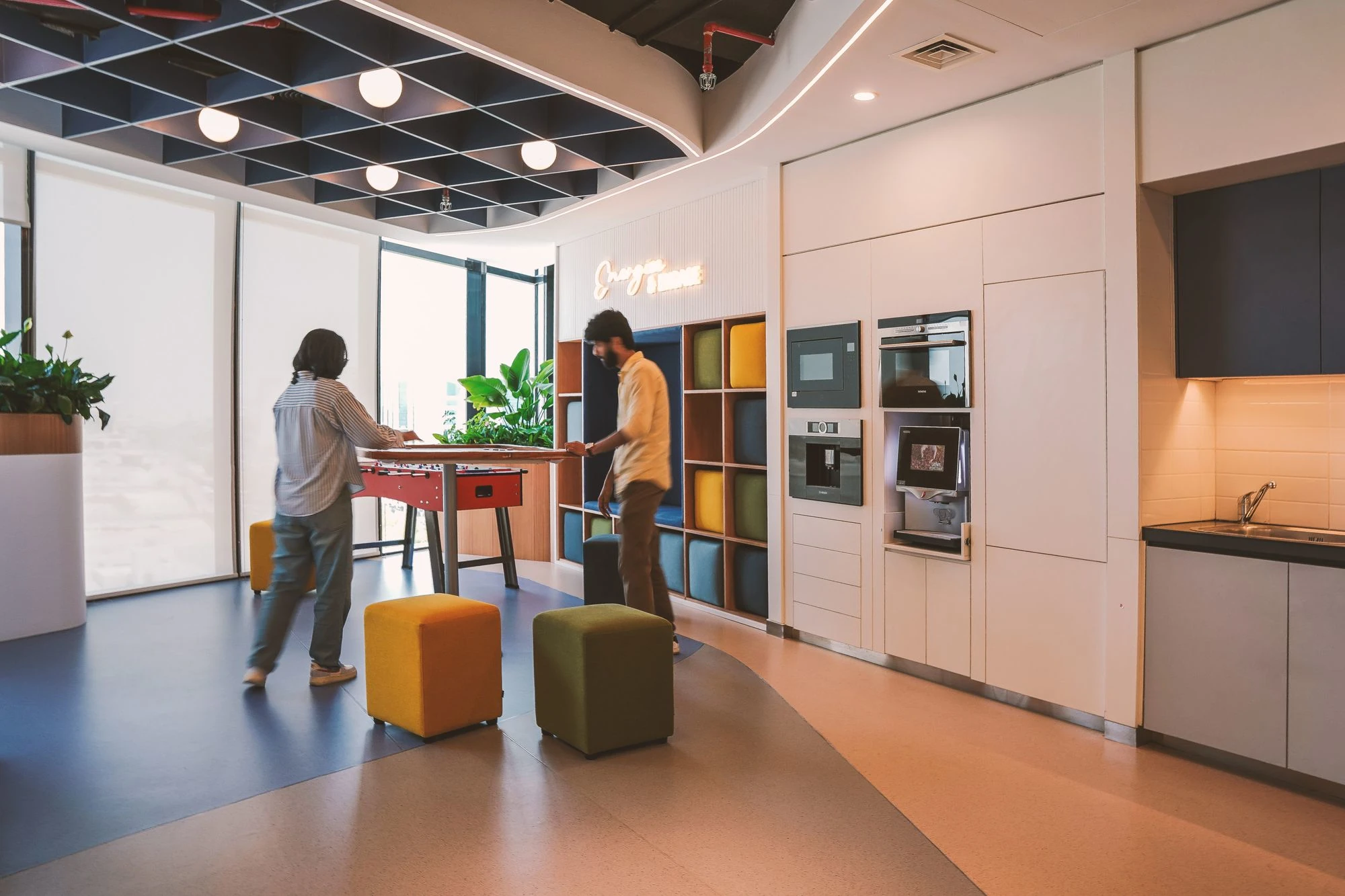 Siemens breakout area with foosball table and colorful ottoman seating, Jaidah Square, Doha, by Daya