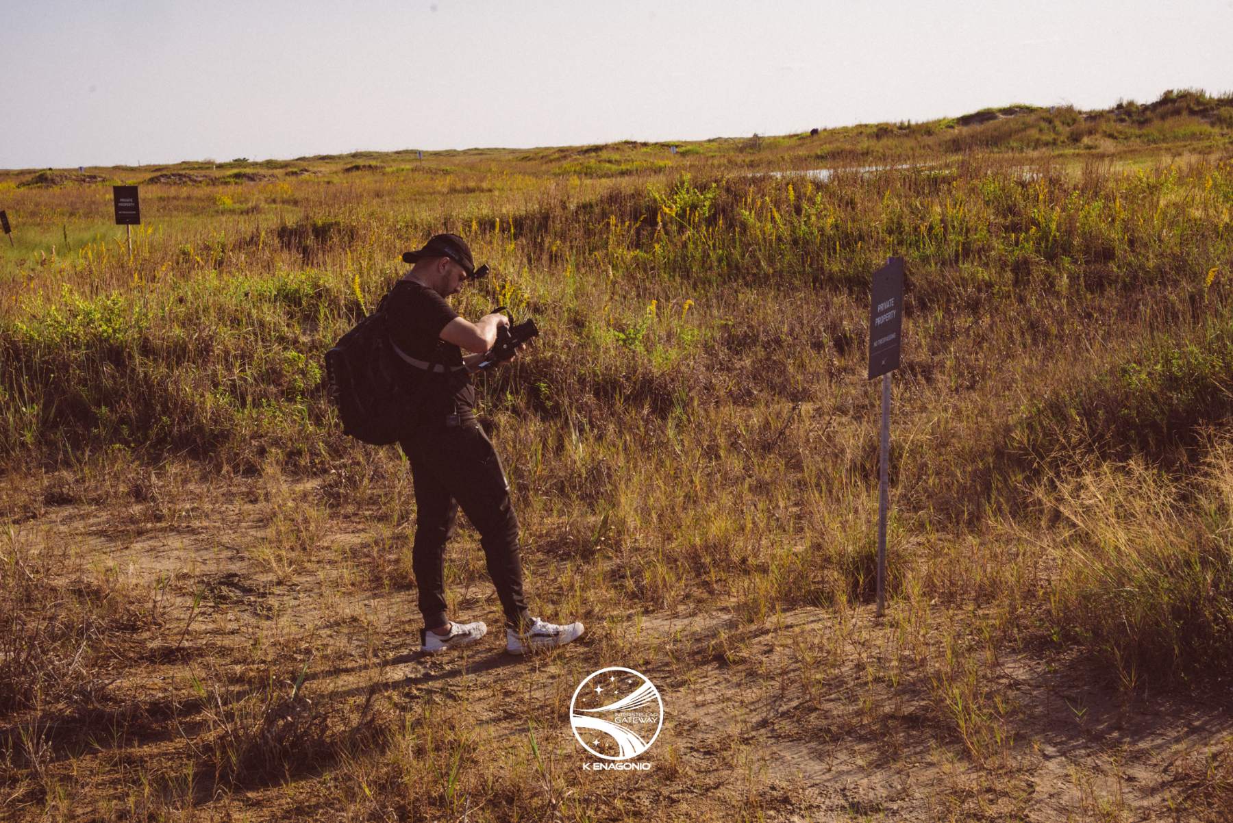 A photographer working in the coastal scrub near the Starbase launch site.