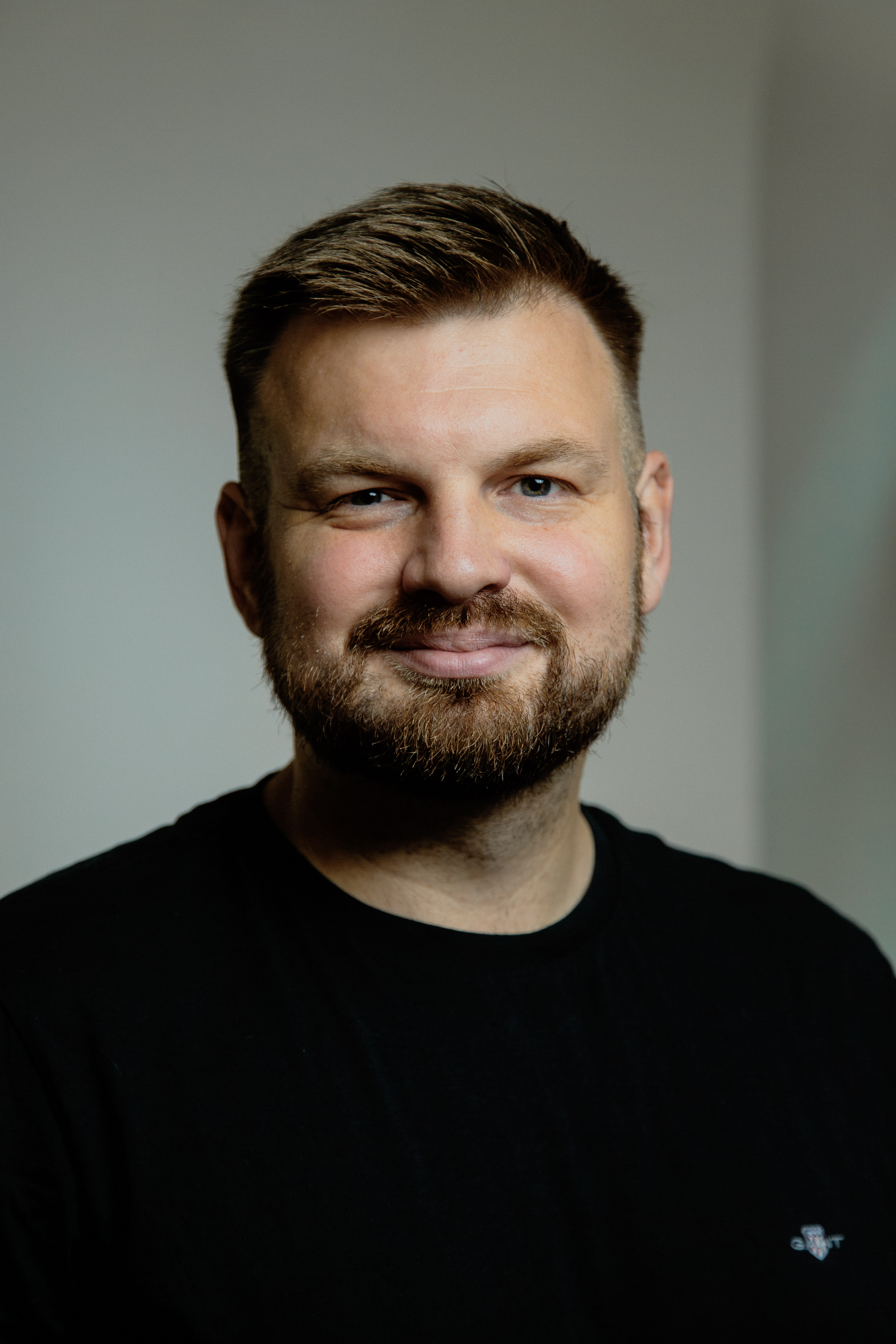 Man in black shirt smiling