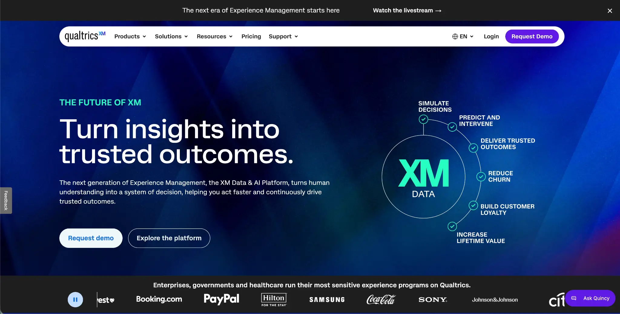 Qualtics XM homepage with the headline "Turn insights into trusted outcomes," with two call to action buttons, one, a “Request demo” button and the other “Explore the platform”