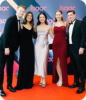 Five young adults in formal attire posing on a red carpet with an 'isaac' backdrop.