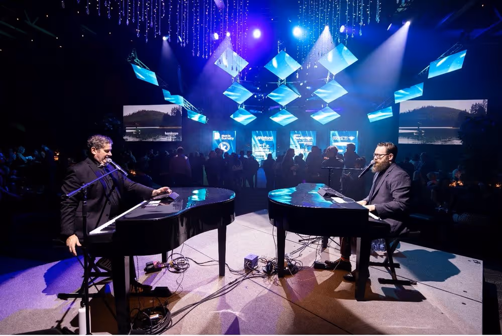 Two men playing the piano