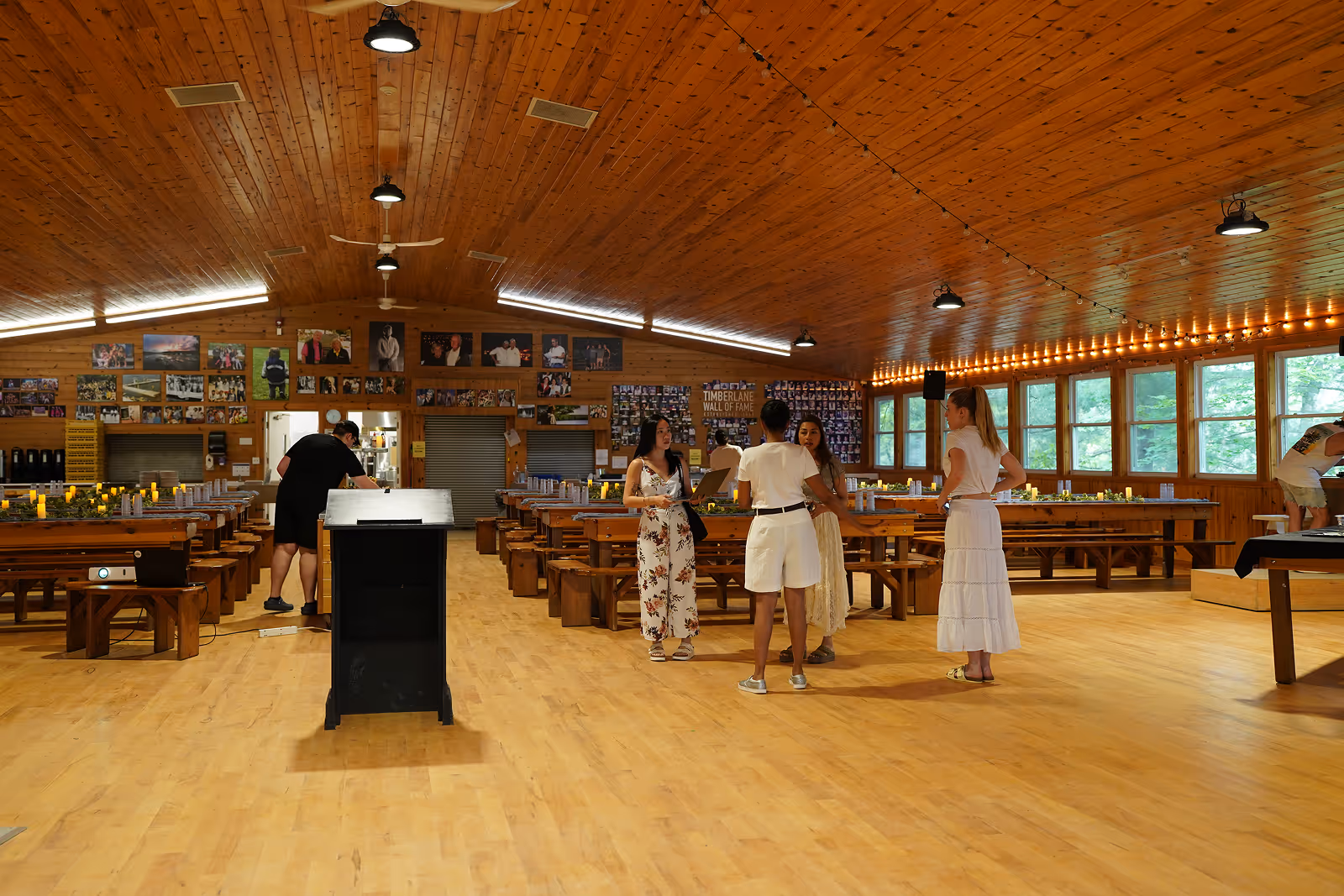 a large, rustic wooden hall set up for an event or gathering.
