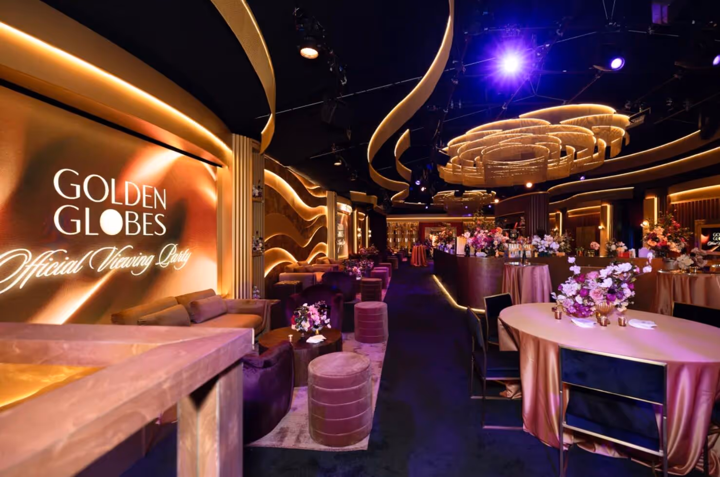 Elegant Golden Globes Official Viewing Party setup with gold and purple decor, satin tables, and floral centerpieces