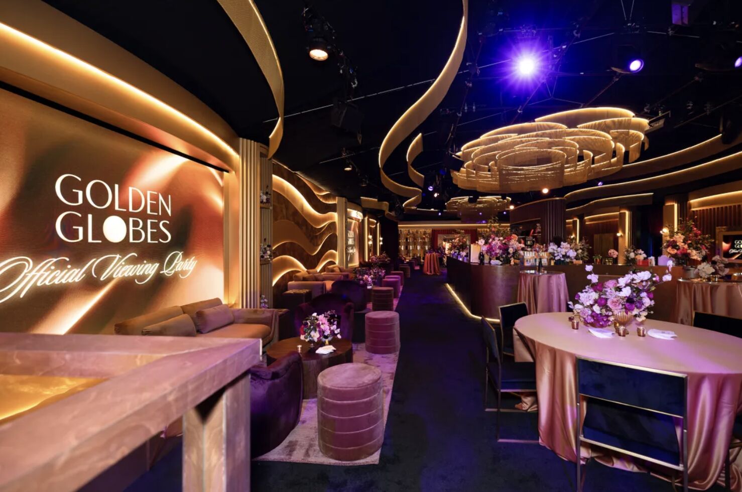 Elegant Golden Globes Official Viewing Party setup with gold and purple decor, satin tables, and floral centerpieces