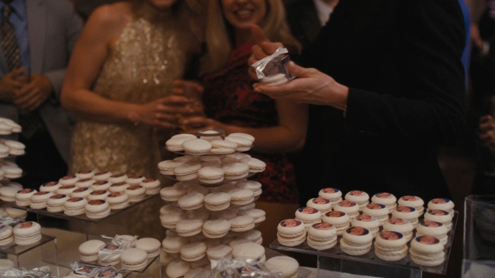 Macarons printed with guests' photos, displayed on clear risers