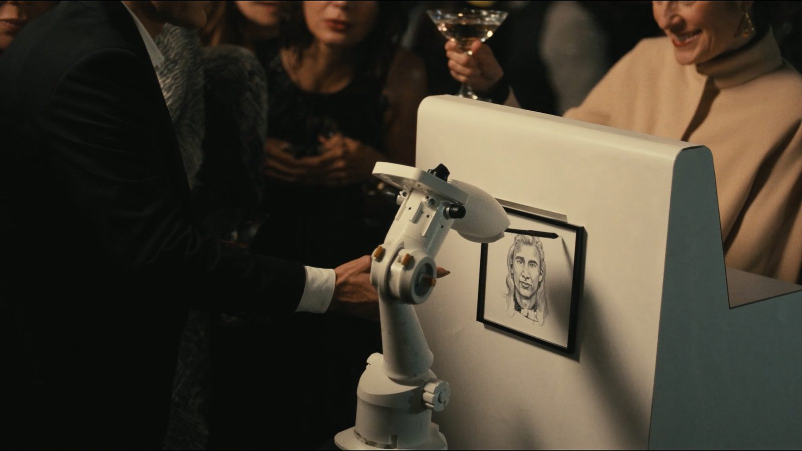 Robotic arm sketching a guest's portrait at a kiosk