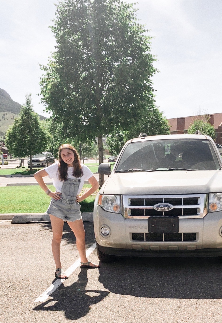 Girl standing by her car