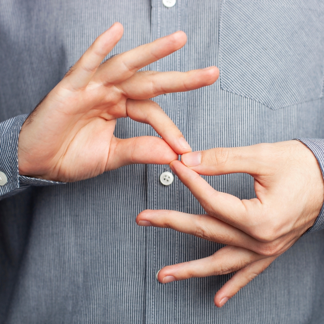 A set of hands making the interpreter sign in front of a gray striped dress shirt
