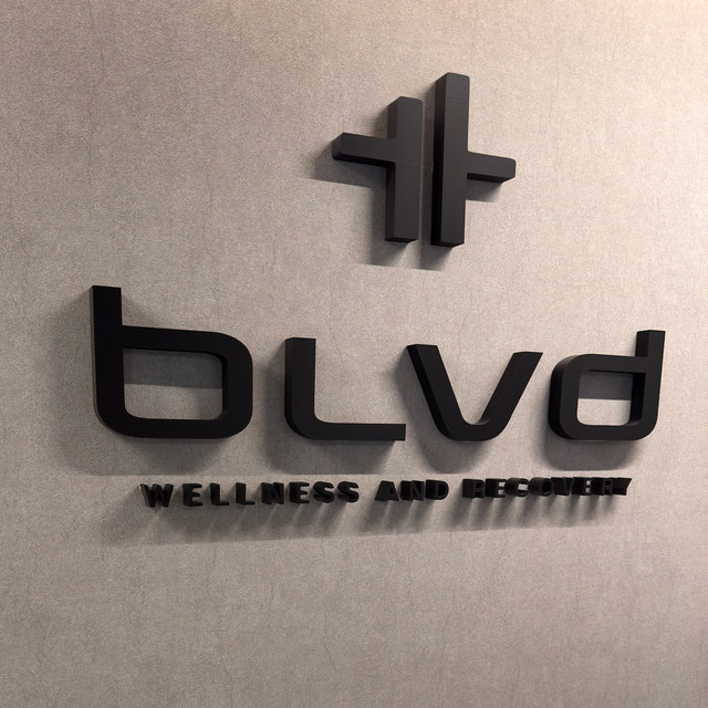 The BLVD Wellness and Recovery signage mounted on the reception wall