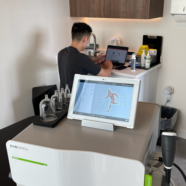 The Storz MASTERPULS shockwave unit in a BLVD treatment room, cupping set alongside