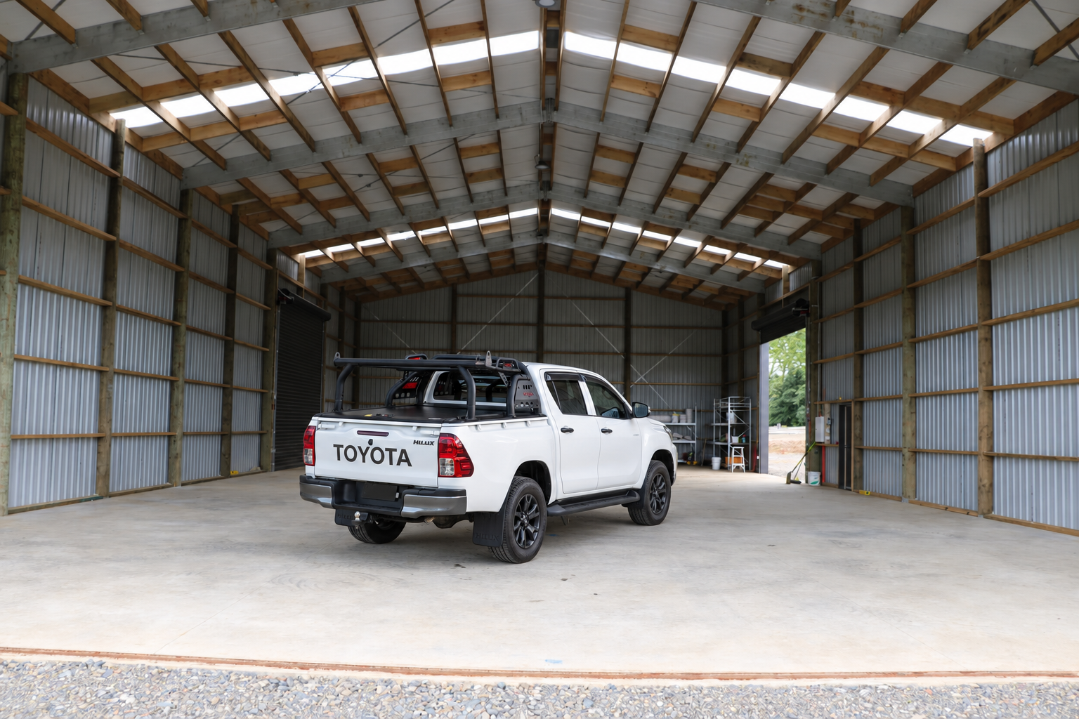 White tradie’s ute parked inside a hangar