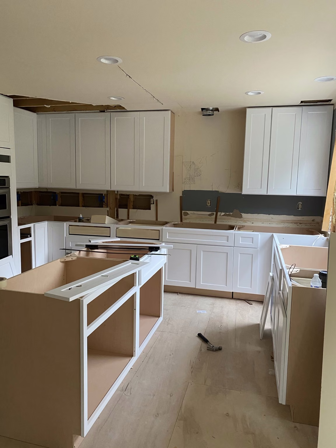 Kitchen cabinetry and island installation in progress in Bellevue