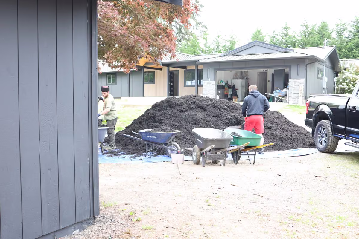 Oleg and Sons team members working outside a home