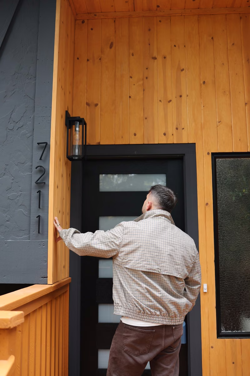 On-site review of wood cladding and a dark entry door