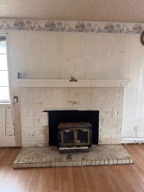 Mukilteo, WA — Original painted-brick fireplace, projecting hearth, mantel, and insert.