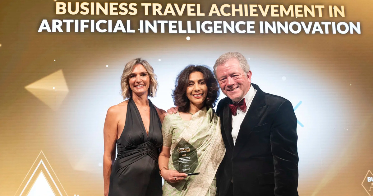 Three people smile under the Business Travel Achievement in Artificial Intelligence Innovation title, one holding the trophy