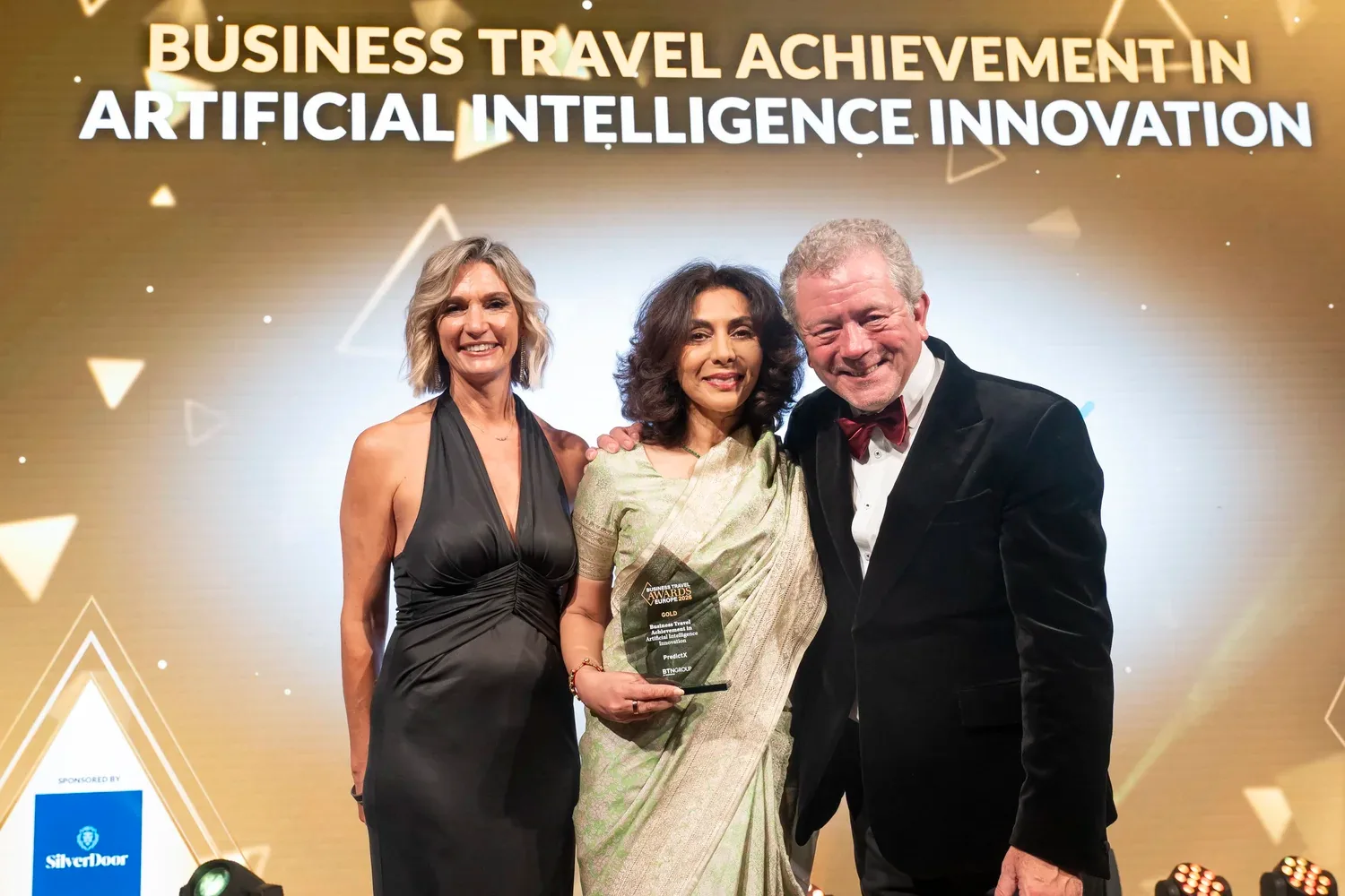 Co-founder Ayesha Shah holds the gold between two people in black, the Artificial Intelligence Innovation title above them