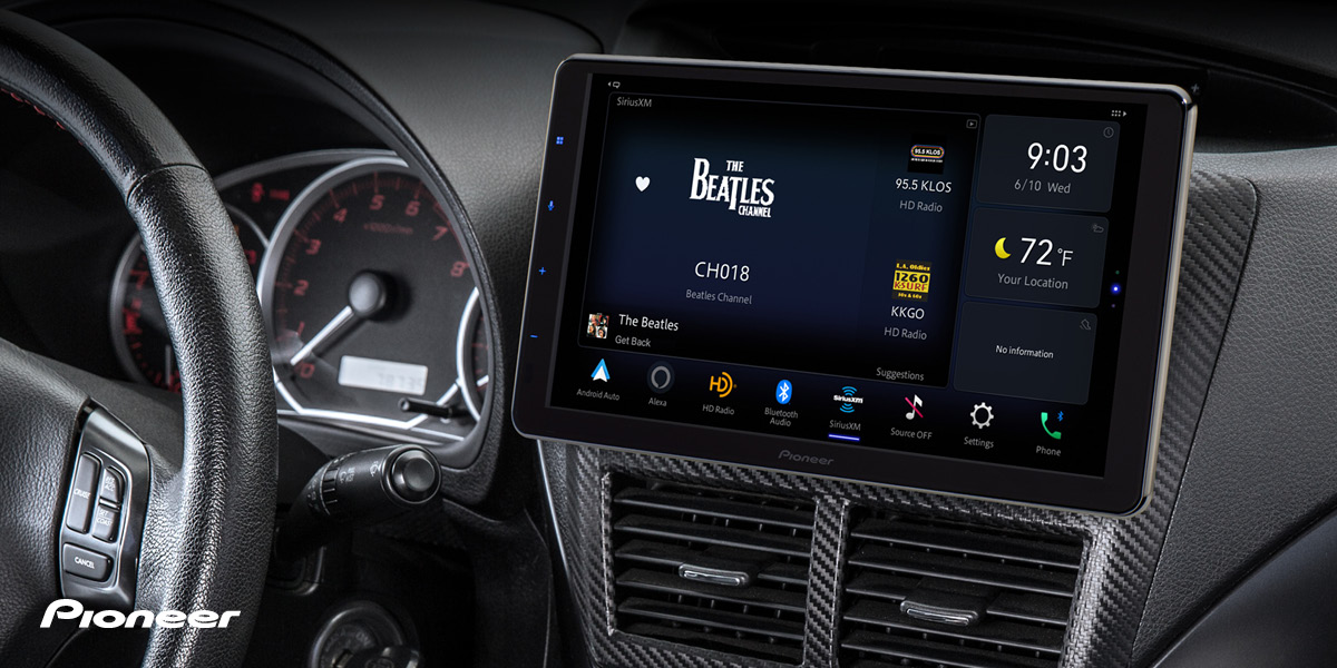 Car dashboard showing a Pioneer touchscreen displaying The Beatles Channel on SiriusXM with controls and climate info.