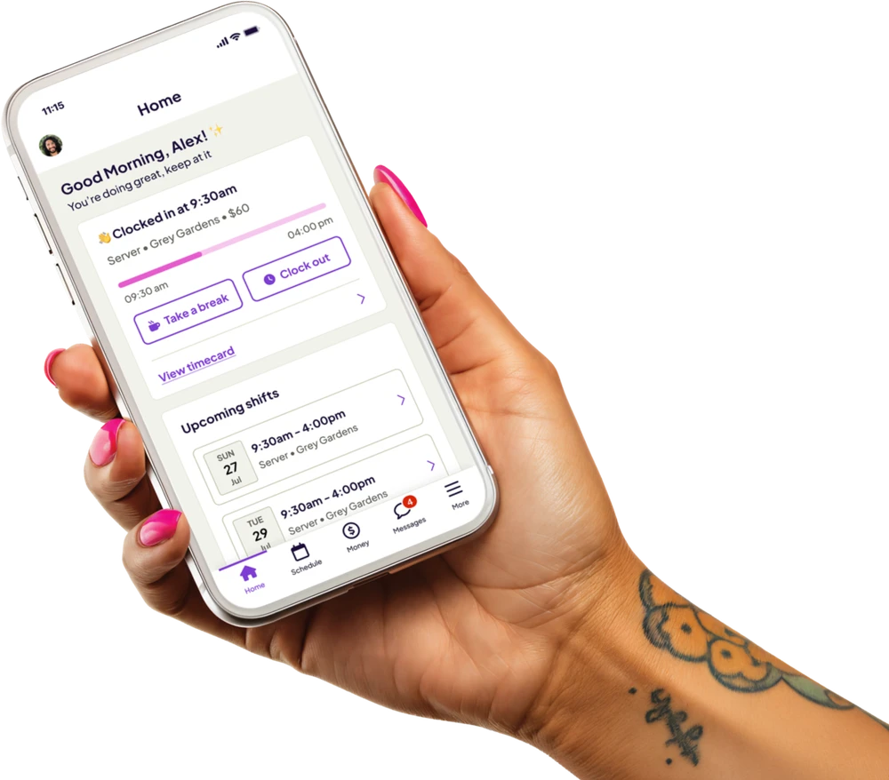 Hand holding a phone showing the Homebase app