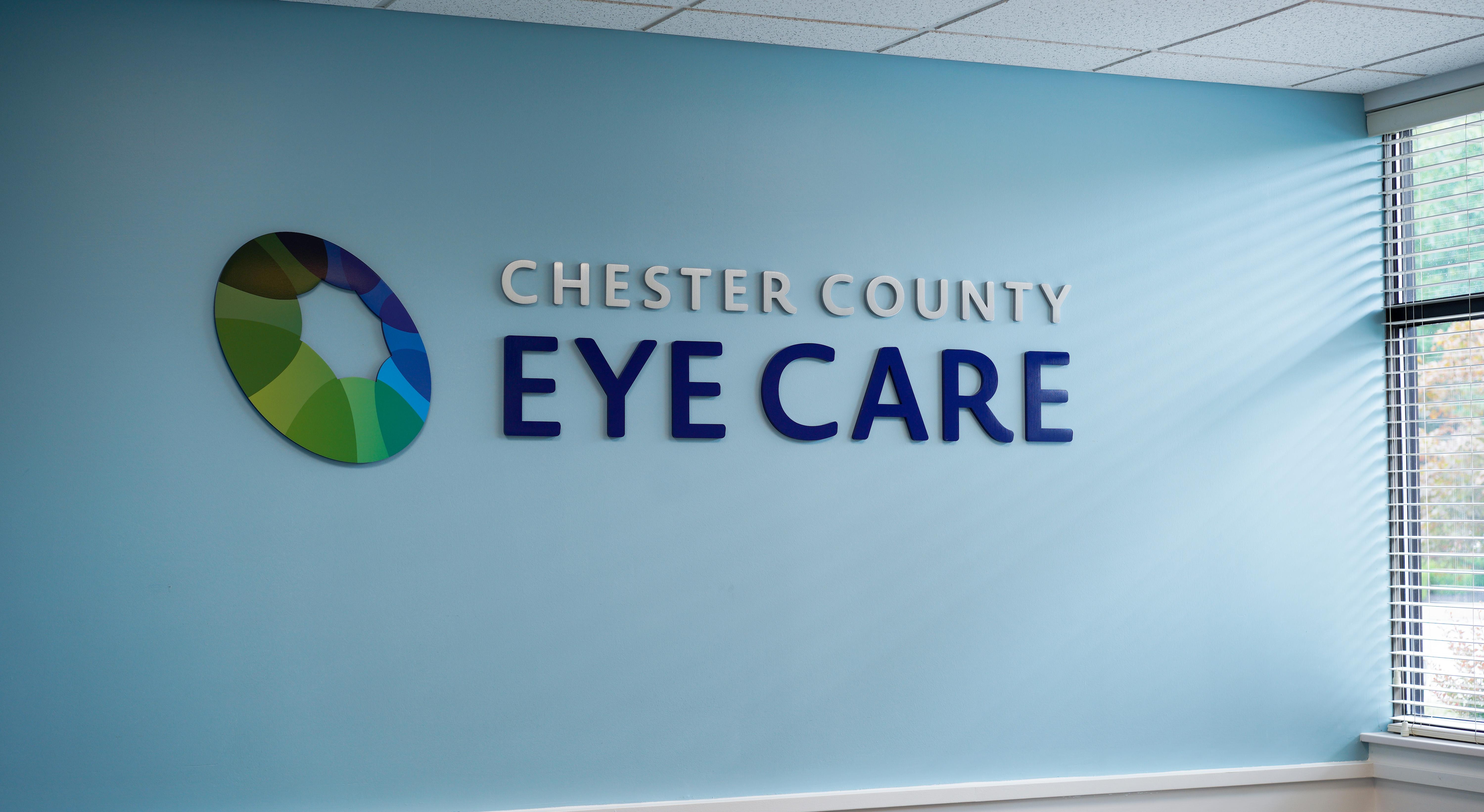 Blue wall with Chester County Eye Care logo 