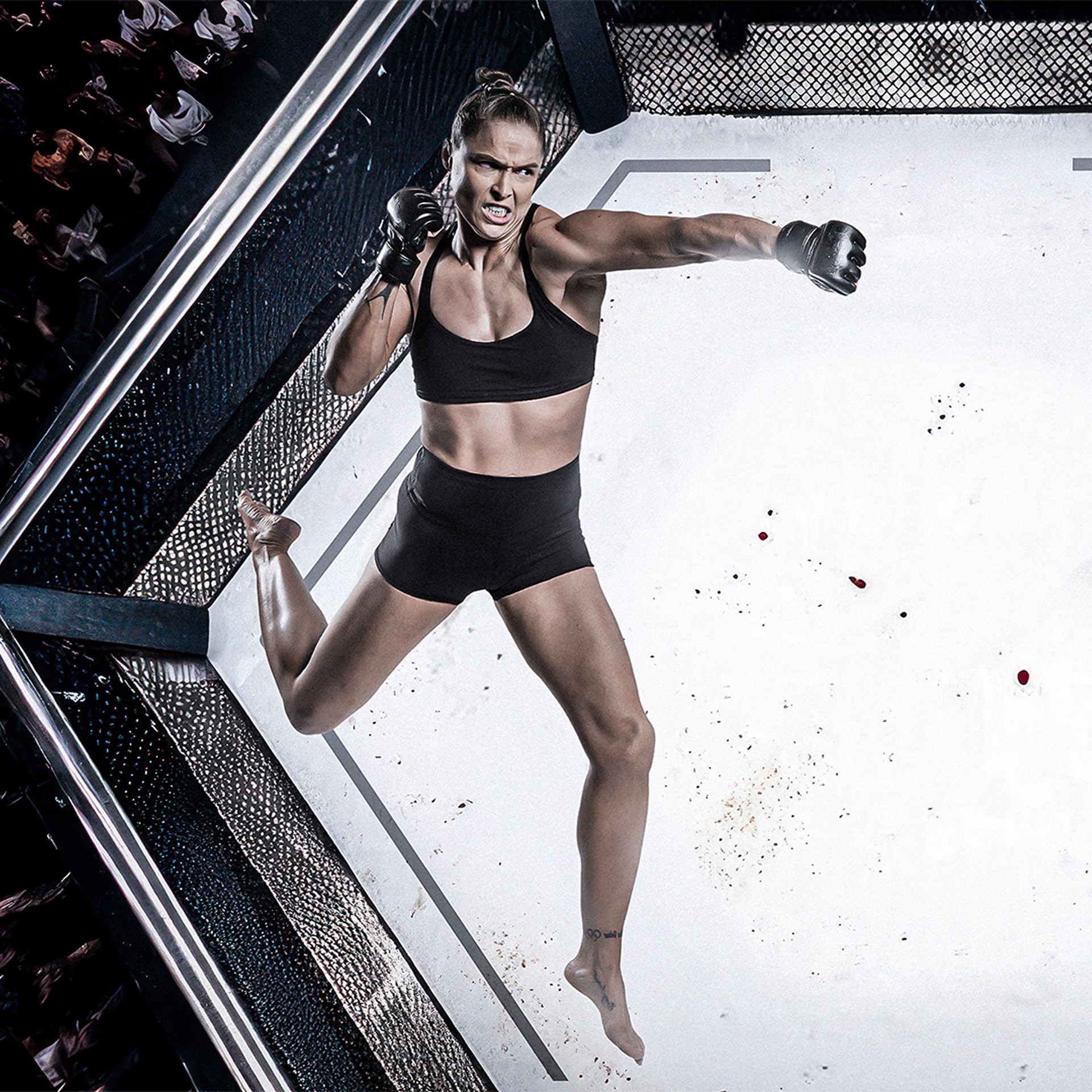 Female MMA fighter in black sportswear delivering a powerful punch mid-air inside a caged octagon.