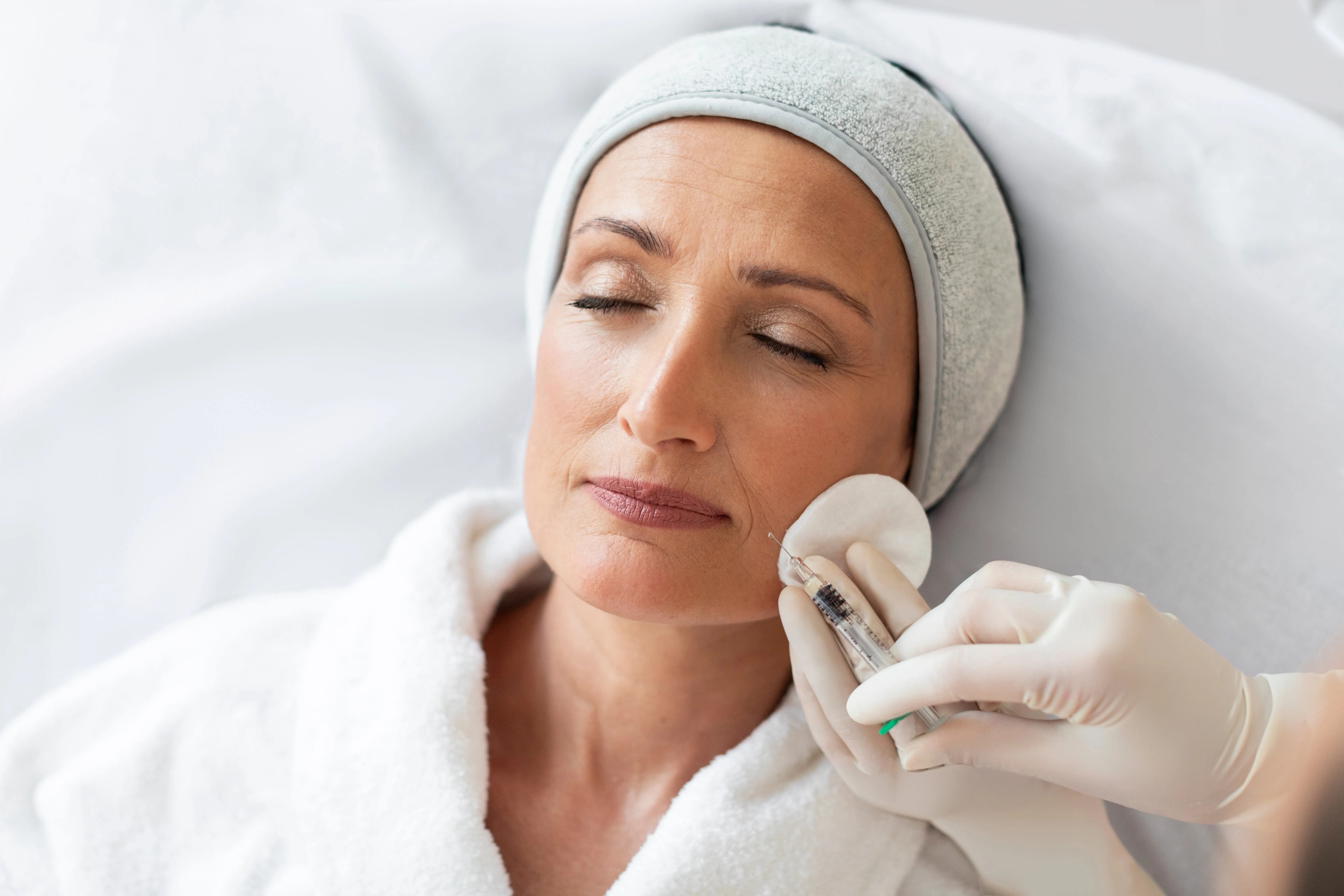 Woman receiving professional facial skincare treatment
