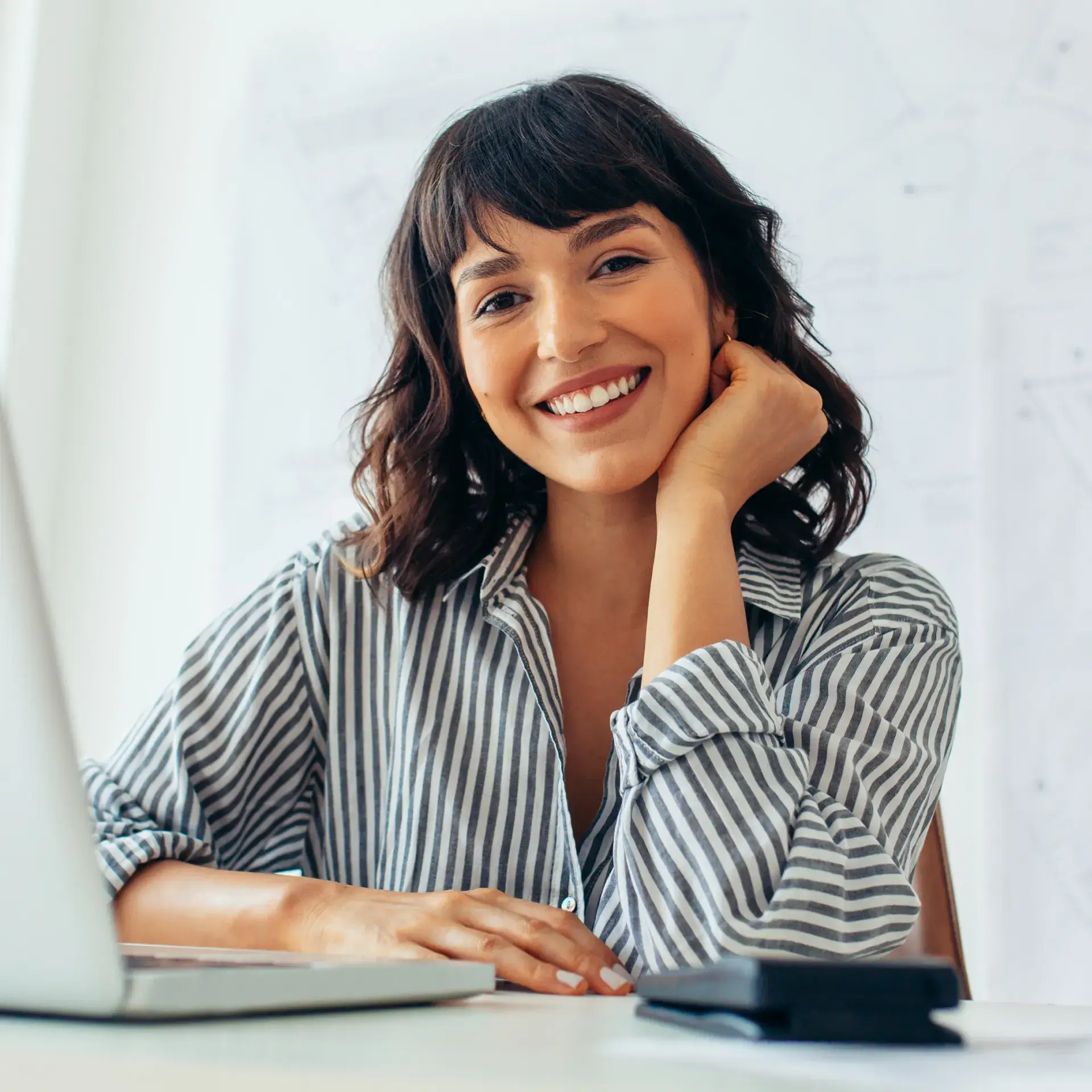 A woman sitting in front of a laptop computer.