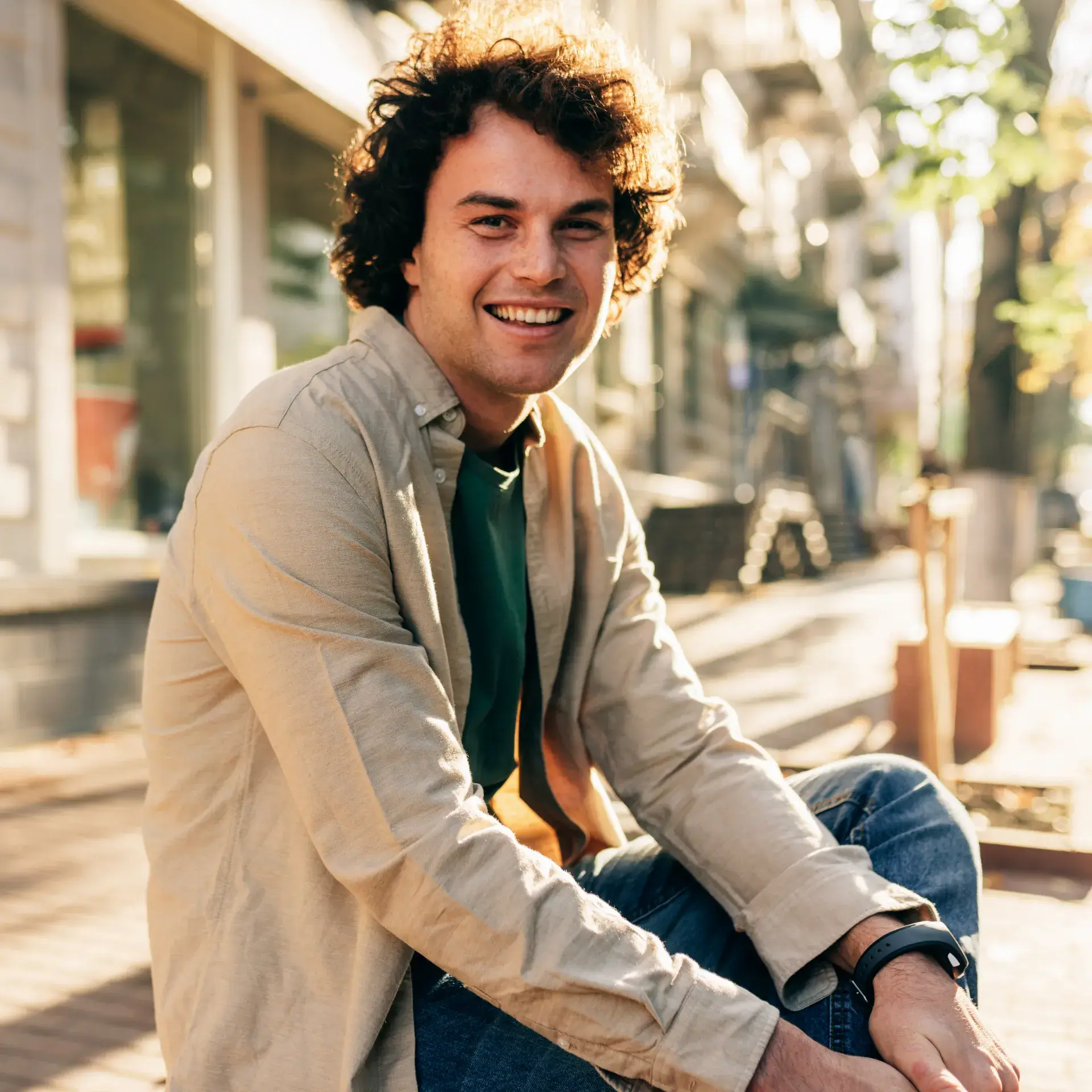 a man sitting on a bench wearing a green tie