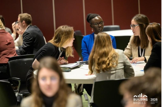A group of people sitting around a tableAI-generated content may be incorrect.