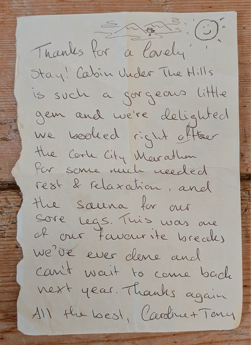 Handwritten note thanking cabin hosts for a lovely stay and relaxing sauna after the Cork City Marathon.