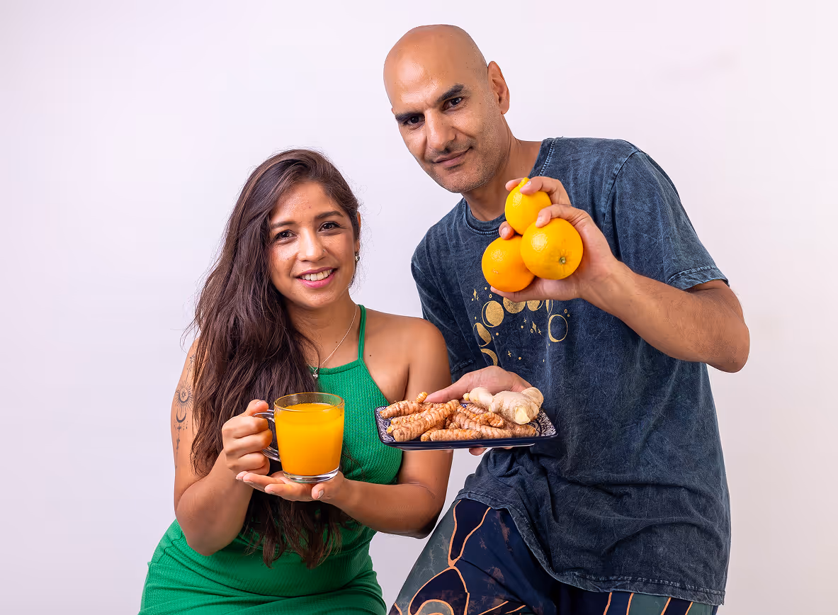 The founders of Ritual Cubes holding a steaming mug and the raw ingredients. 