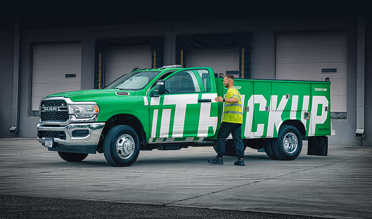 Professional truck driver entering Truckup vehicle for delivery job