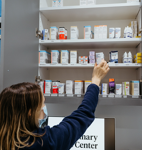 veterinary eye center team member reaching for medication