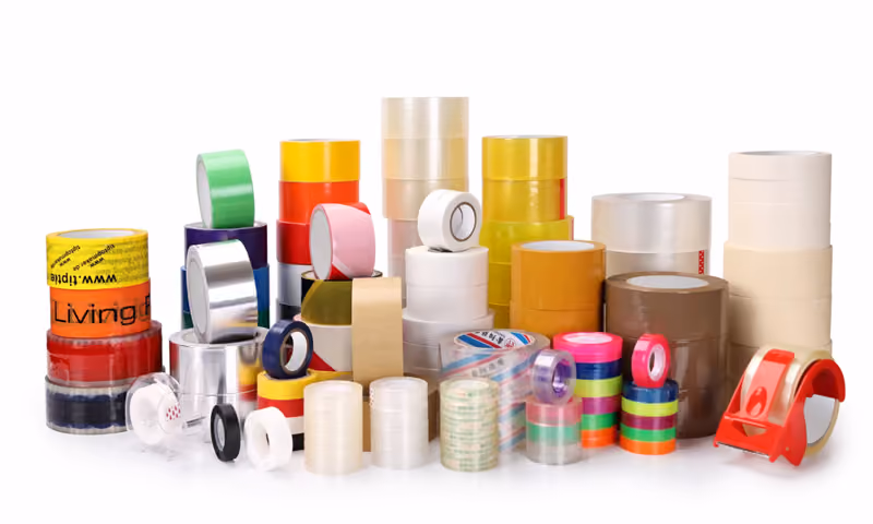 Packing tape rolls and handheld tape dispensers
