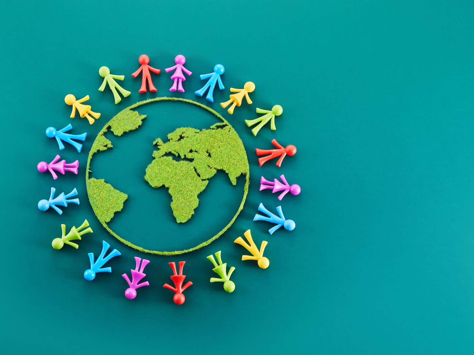 Green world map encircled by multicolored figures representing Wellthy’s global caregiving support and connection across countries